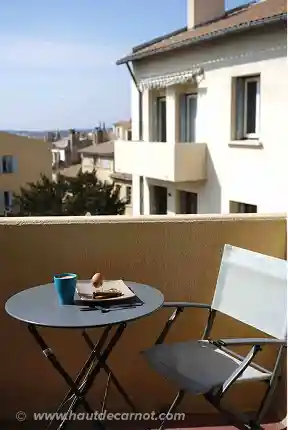 View of the balcony with its table and chairs