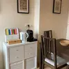 View of the kitchen showing the breakfast hub with toaster, electric kettle, Nespresso machine and a large table with 4 chairs
